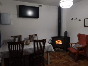 a dining room with a table and a fireplace at Casa rural Ardetxal a 16km de Logroño y Laguardia in Viñaspre