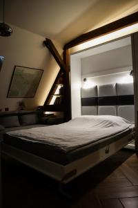 a bedroom with a bed and a stair case at Attic Studio Poznań-Jeżyce in Poznań
