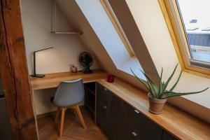 an attic office with a desk and a chair at Attic Studio Poznań-Jeżyce in Poznań