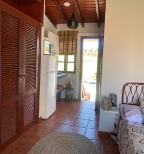 a room with a kitchen with a refrigerator and a door at Eagle Studio in San Miguel de Abona