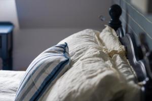 a close up of a bed with a pillow on it at Secluded Island Retreat - in the heart of the Anchorage in West Mersea