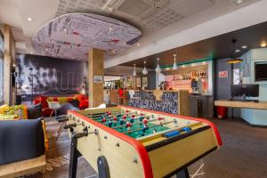 a ping pong table in a room with a bill at B&B HOTEL Chartres Centre Cathédrale in Chartres