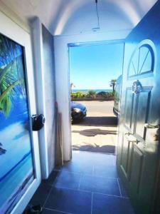 a door to a room with a view of a car at La Casa di Pegli 21r in Genova