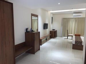 a hotel room with a bed and a mirror at Valluvanad Residency in Perintalmanna