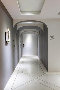 an empty hallway with a white corridor at Volve Hotel Bangkok in Bangkok