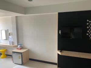 a room with a wall with a flat screen tv at Le Lerts Living Hotel in Khon Kaen