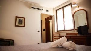 Postel nebo postele na pokoji v ubytování Bagno Santo Residence
