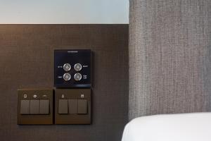 a room with a control panel on a wall at Volve Hotel Bangkok in Bangkok
