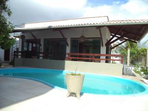 a swimming pool in front of a house at Pousada Na Beira do Mar in Baía da Traição