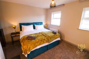 a bedroom with a large bed with a yellow blanket at Cheerful Queens Quarters Boutique Rooms in Hartford