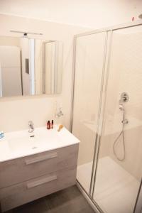 a bathroom with a shower and a sink and a mirror at Perla Vacanza in Santa Marinella