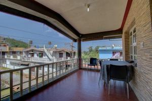 a balcony with a table and chairs on it at Dhruva Homestay in Madikeri