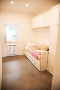 A bed or beds in a room at Perla Vacanza