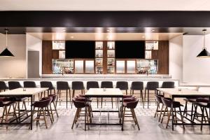 a restaurant with tables and chairs and a bar at Hyatt Place Phoenix/Downtown in Phoenix