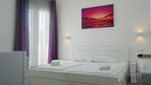 Postel nebo postele na pokoji v ubytování Angelina Hotel