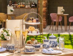 a table with a tray of pastries and drinks on it at Kettering Park Hotel and Spa in Kettering