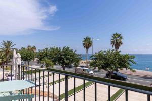 a balcony with a view of the ocean and a street at Appartements Vivo in Cagnes-sur-Mer
