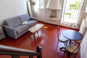 a living room with a couch and a table at Appartements Vivo in Cagnes-sur-Mer