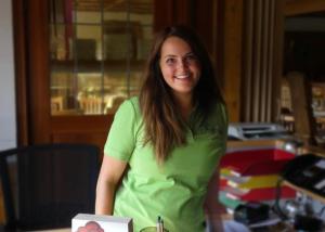 a woman in a green shirt sitting at a table at Landgasthof Jostalstüble in Titisee-Neustadt