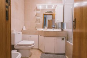a white bathroom with a toilet and a sink at Best Houses 66 - Côté Dune in Ferrel +13 photos