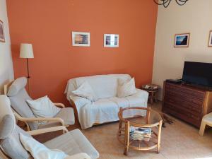 a living room with a couch and chairs and a tv at Casa Katharina - Valle Gran Rey in Calera