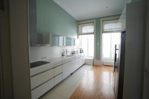 a kitchen with white cabinets and a large window at BF 677 in Vila do Conde