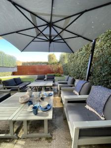 a group of tables and chairs under an umbrella at BF 677 in Vila do Conde