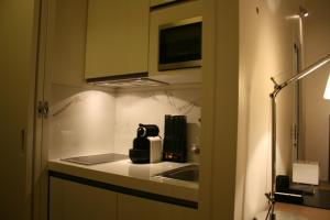 a kitchen with a sink and a counter top at Cirque Deluxe Studio Apartment in Paris