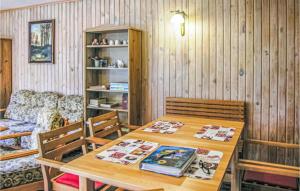 a dining room with a table and a couch at Awesome Home In Lubiecin With 3 Bedrooms And Outdoor Swimming Pool in Lubięcin