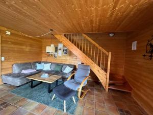 a living room with a couch and a staircase at JS Feriendomizile Haus Sonnenschein Bettwäsche Handtücher inkl in Hasselfelde