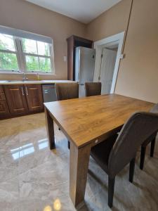 a kitchen with a wooden dining table and chairs at Mountmahon House in Abbeyfeale