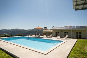 a swimming pool in the backyard of a house at Matos Casas de Campo in Cabeceiras de Basto