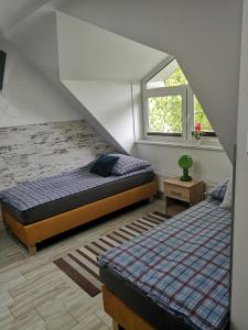 a bedroom with two beds and a window at City Center Apartments Kilińskiego 22 in Augustów