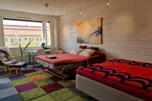 a bedroom with two beds and a table and chairs at Lovely 7th floor studio full of color, enjoy! in Tampere