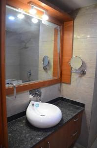 a bathroom with a sink and a mirror at Platinum Palace in Gurgaon