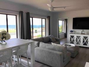 a living room with a couch and a table at SALT @ North Beach WALLAROO (absolute beachfront) in Wallaroo