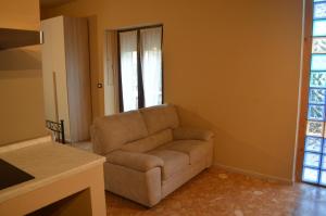 a living room with a couch and a window at Podere San Marco in Bonate di Sopra