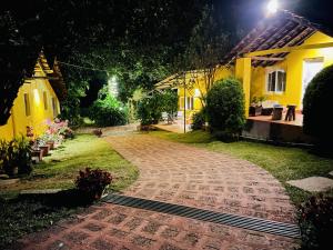 a cobblestone path in front of a house at night at Guddadamane Homestay in Chikmagalūr