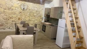 cocina y comedor con mesa y nevera en GUEST HOUSE TZIA UDRONI, en Ossi