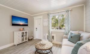 a living room with a white couch and a window at Driftwood Villas at Anna Maria Island Inn in Holmes Beach