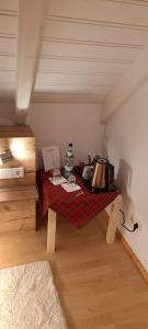 a small room with a table in a attic at B&B Talstation in Hörselberg-Hainich