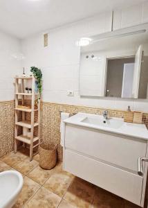 y baño con lavabo blanco y espejo. en Retama del Teide, Puerto de la Cruz, en Puerto de la Cruz