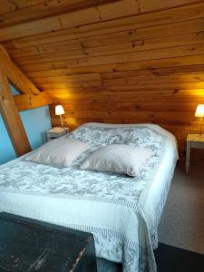 a bedroom with a bed with a wooden ceiling at Chambre d'hôtes - Le jardin des Patissons in La Foret Du Parc