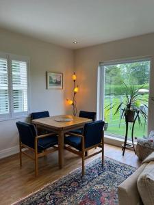 a living room with a wooden table and chairs at Adorable one bedroom apartment with balcony in Newtownards