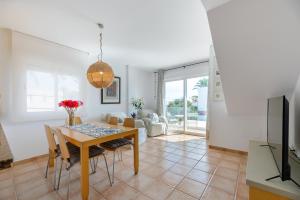 a dining room with a table and chairs at Edificio can Sord Apto nº 2 in La Savina