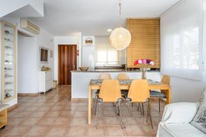 a kitchen and dining room with a table and chairs at Edificio can Sord Apto nº 2 in La Savina