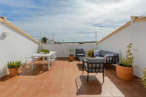 a balcony with a table and chairs on a roof at Edificio can Sord Apto nº 2 in La Savina