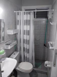 a bathroom with a toilet and a shower curtain at Departamento Ciudad Mendoza in La Cieneguita