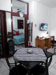 a room with a table and a bed and a mirror at Departamento Ciudad Mendoza in La Cieneguita