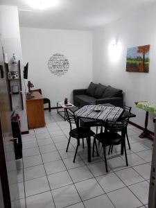 a living room with a table and a couch at Departamento Ciudad Mendoza in La Cieneguita